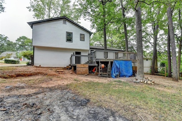 rear view of property featuring a wooden deck