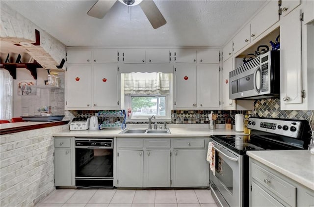 kitchen featuring a textured ceiling, sink, ceiling fan, appliances with stainless steel finishes, and white cabinets