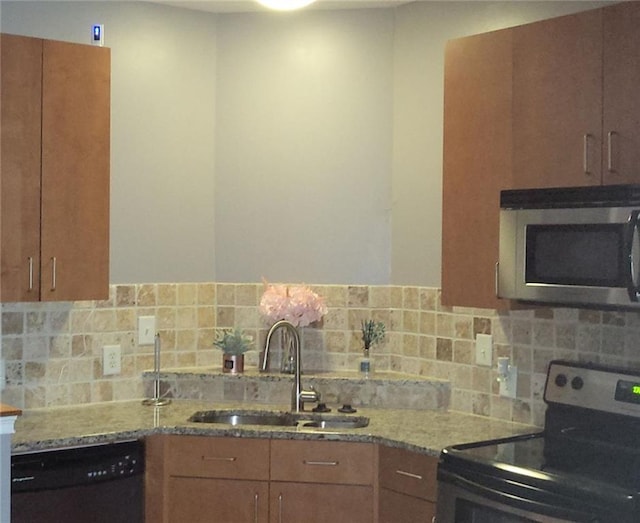 kitchen with black dishwasher, light stone counters, tasteful backsplash, sink, and range with electric cooktop