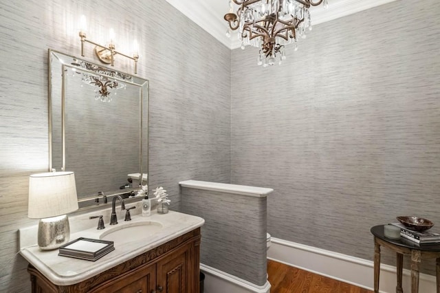 bathroom featuring hardwood / wood-style floors, vanity, and a notable chandelier