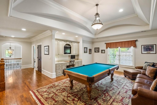 rec room with a raised ceiling, crown molding, hardwood / wood-style floors, a chandelier, and pool table