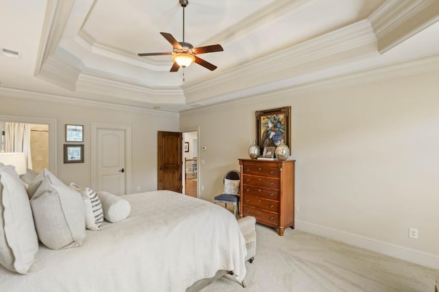 bedroom featuring a raised ceiling, ceiling fan, light carpet, and ornamental molding