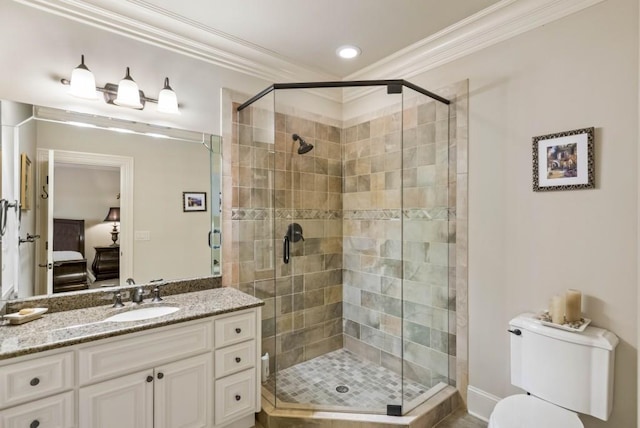 bathroom with toilet, vanity, a shower with shower door, and ornamental molding