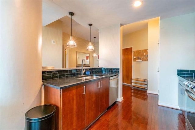 kitchen with sink, tasteful backsplash, decorative light fixtures, dark hardwood / wood-style floors, and stainless steel appliances