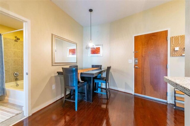 dining room with dark hardwood / wood-style flooring