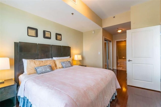 bedroom with dark wood-type flooring