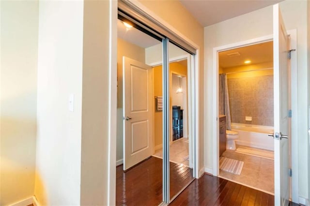 hallway with dark wood-type flooring