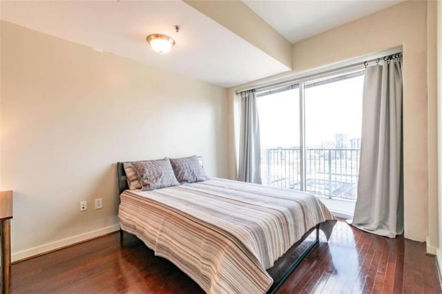 bedroom featuring dark hardwood / wood-style flooring and access to exterior