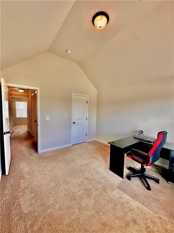 520 Harmony Way, Locust Grove, GA 30248 - home office featuring light colored carpet, lofted ceiling, and baseboards