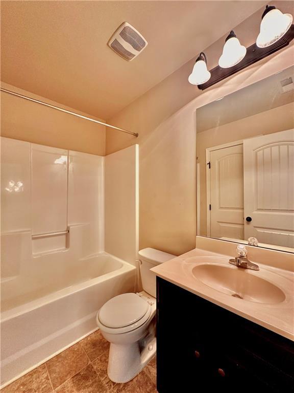 520 Harmony Way, Locust Grove, GA 30248 - bathroom with vanity, toilet, and shower / washtub combination