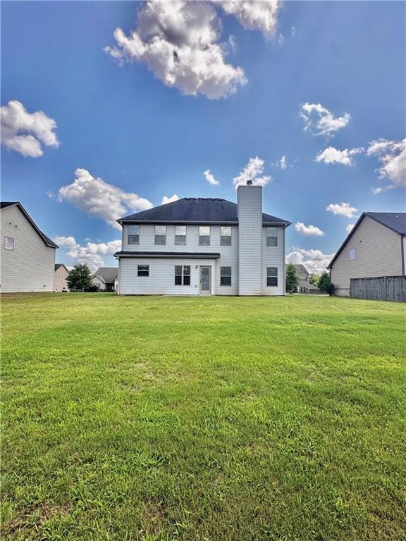 520 Harmony Way, Locust Grove, GA 30248 - rear view of property with a yard and a chimney