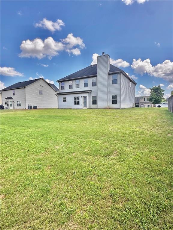 520 Harmony Way, Locust Grove, GA 30248 - back of house with a lawn and a chimney
