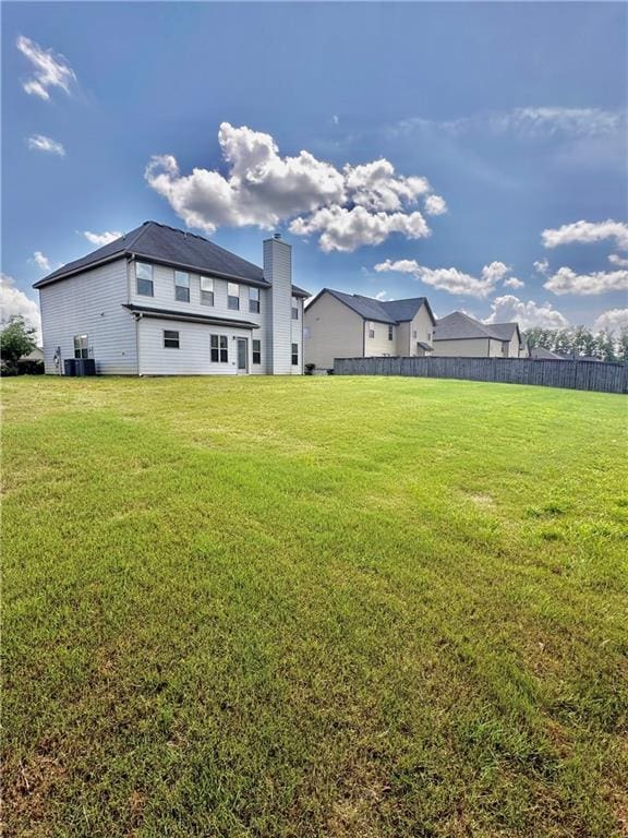 520 Harmony Way, Locust Grove, GA 30248 - back of house with a chimney and cooling unit