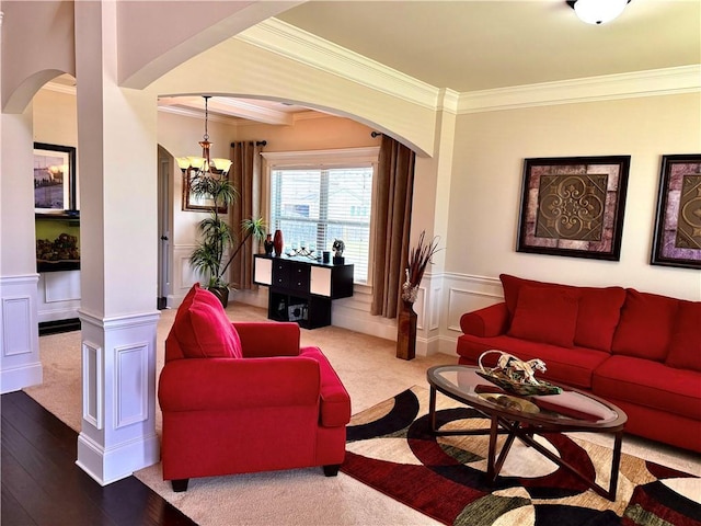 520 Harmony Way, Locust Grove, GA 30248 - living area with arched walkways, crown molding, a wainscoted wall, a decorative wall, and a chandelier