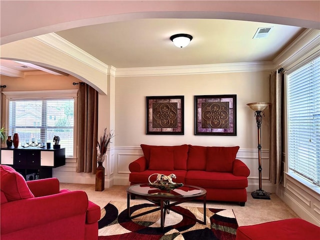 520 Harmony Way, Locust Grove, GA 30248 - carpeted living area featuring crown molding, arched walkways, a wainscoted wall, healthy amount of natural light, and a decorative wall