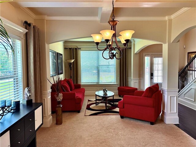 520 Harmony Way, Locust Grove, GA 30248 - carpeted living area with arched walkways, crown molding, a chandelier, a decorative wall, and a wainscoted wall