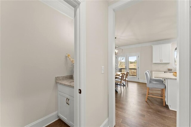 corridor with french doors, dark hardwood / wood-style flooring, and crown molding