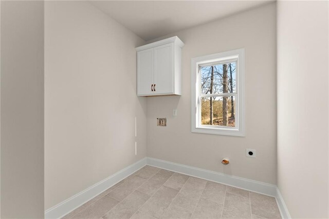 laundry area with cabinets and hookup for an electric dryer