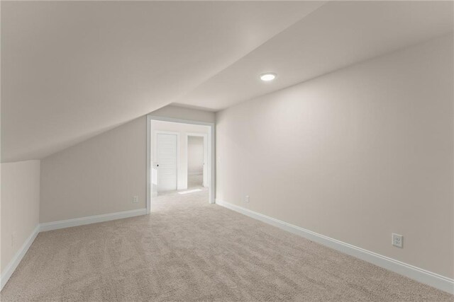 bonus room featuring light carpet and lofted ceiling