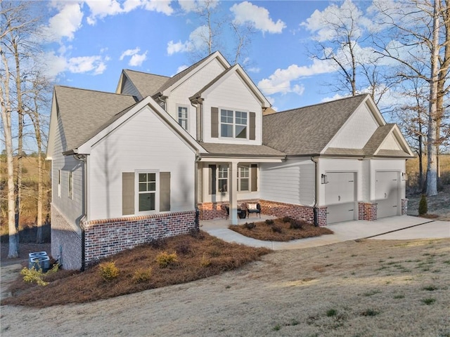 view of front of home featuring cooling unit and a garage