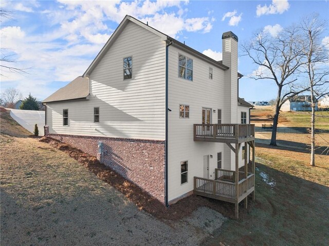 view of home's exterior featuring a deck and a balcony