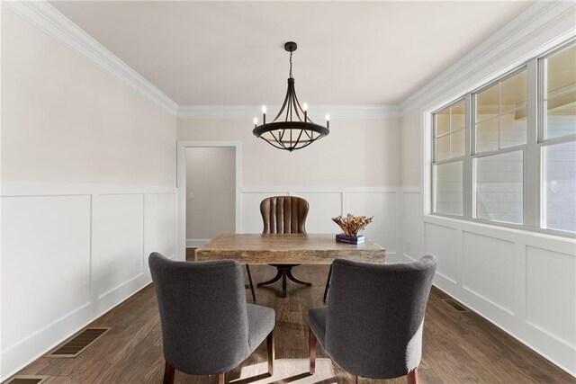 dining room featuring crown molding and dark hardwood / wood-style floors