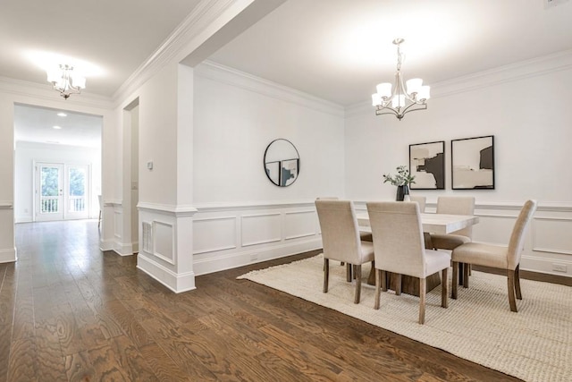 11760 Stratham Dr, Alpharetta, GA 30009 - dining room featuring a chandelier, dark wood finished floors, ornamental molding, a wainscoted wall, and a decorative wall
