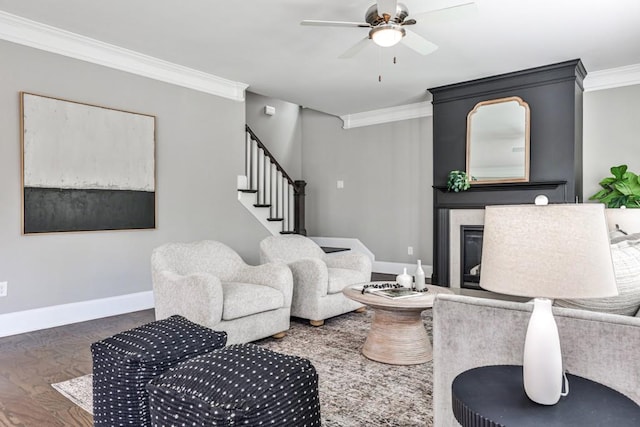 11760 Stratham Dr, Alpharetta, GA 30009 - living room featuring ornamental molding, a glass covered fireplace, stairs, and a ceiling fan