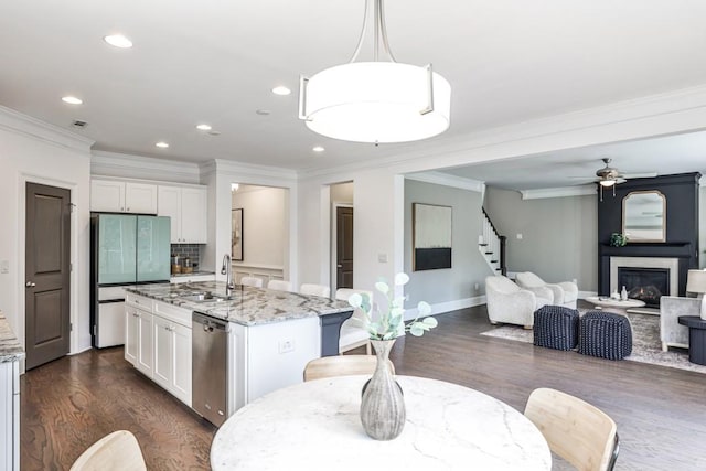 11760 Stratham Dr, Alpharetta, GA 30009 - kitchen featuring fridge, stainless steel dishwasher, dark wood finished floors, ornamental molding, and white cabinetry