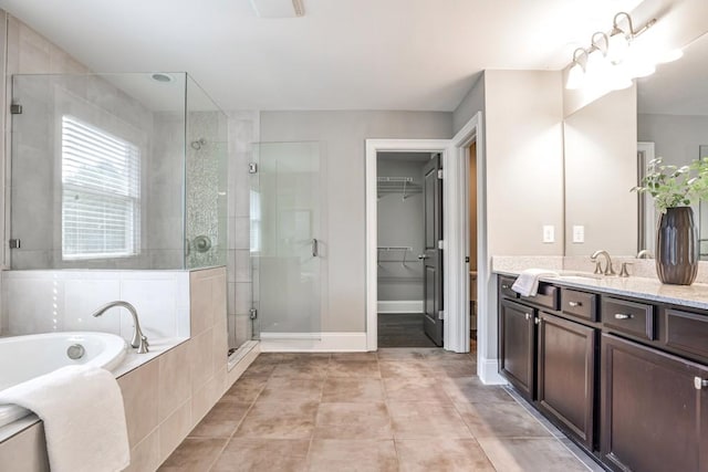 11760 Stratham Dr, Alpharetta, GA 30009 - full bath featuring a stall shower, vanity, a garden tub, a walk in closet, and tile patterned flooring