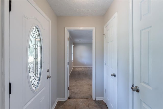 1406 Windy Ridge Ct SE, Conyers, GA 30013 - tiled entrance foyer featuring baseboards, a textured ceiling, and carpet flooring