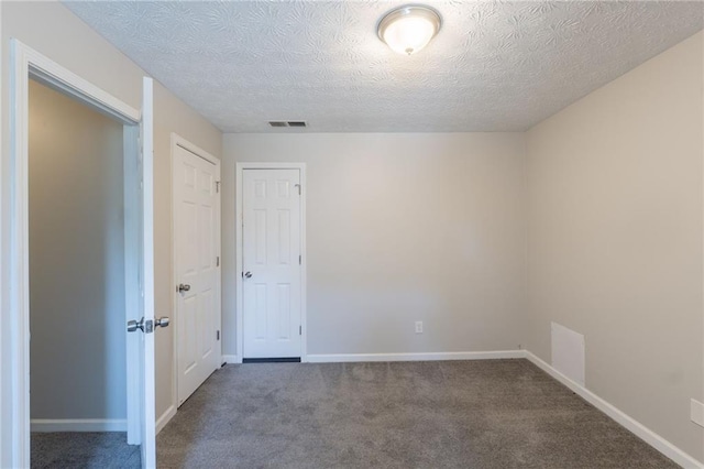 1406 Windy Ridge Ct SE, Conyers, GA 30013 - spare room featuring carpet, a textured ceiling, and baseboards