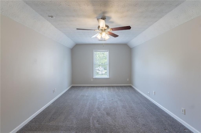 1406 Windy Ridge Ct SE, Conyers, GA 30013 - carpeted empty room featuring ceiling fan, vaulted ceiling, baseboards, and a textured ceiling