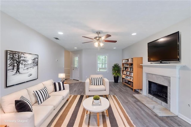 1406 Windy Ridge Ct SE, Conyers, GA 30013 - living area with light wood-style floors, a high end fireplace, ceiling fan, baseboards, and recessed lighting