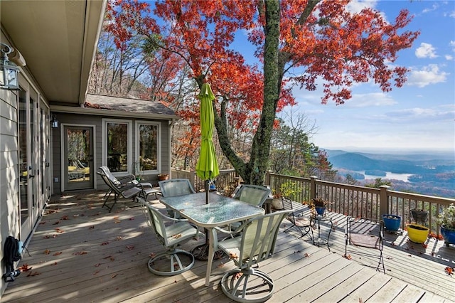 deck featuring a mountain view and outdoor dining space