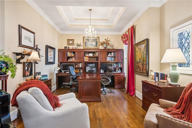 office space with a chandelier, a tray ceiling, dark wood finished floors, and baseboards