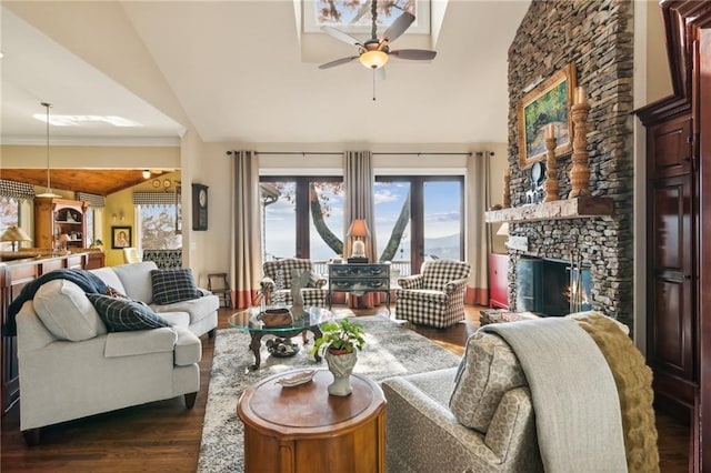 living room featuring high vaulted ceiling, dark wood-type flooring, a fireplace, and a ceiling fan