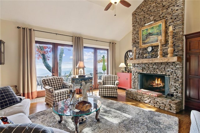 living room with a fireplace, high vaulted ceiling, dark wood finished floors, and a ceiling fan