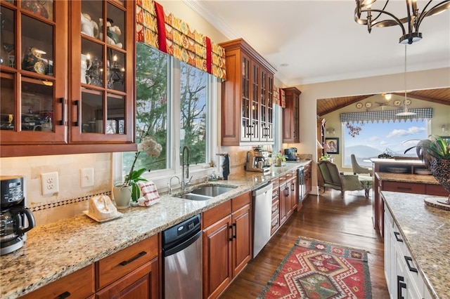 kitchen with decorative light fixtures, stainless steel dishwasher, glass insert cabinets, a sink, and light stone countertops