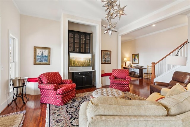 living room featuring baseboards, stairway, and dark wood finished floors