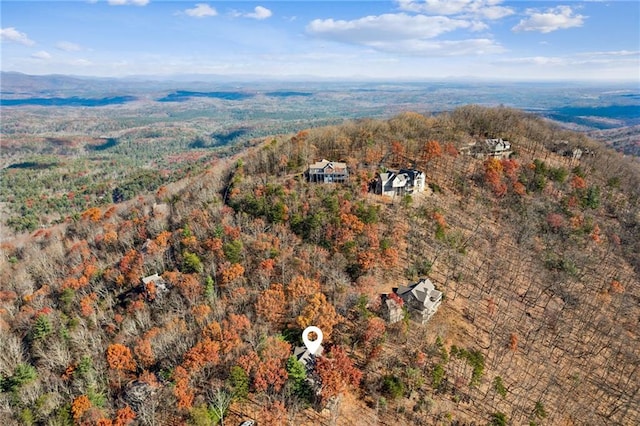 birds eye view of property featuring a view of trees