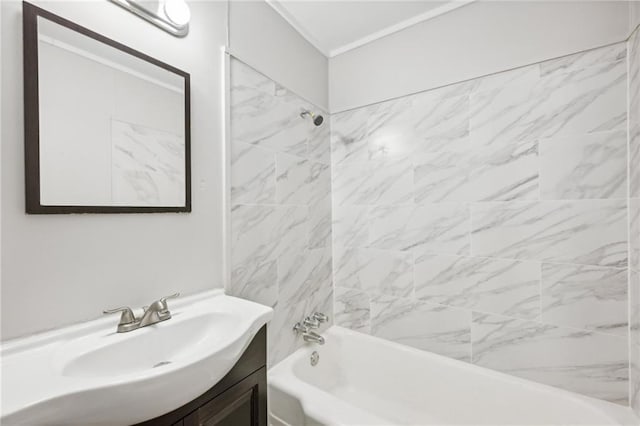 bathroom featuring vanity and tiled shower / bath