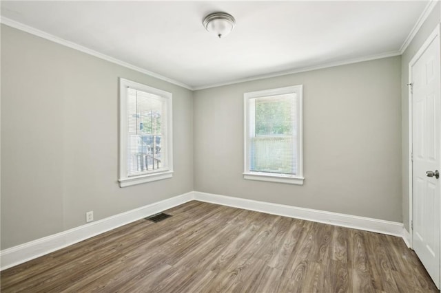 unfurnished room featuring crown molding, dark hardwood / wood-style flooring, and a healthy amount of sunlight