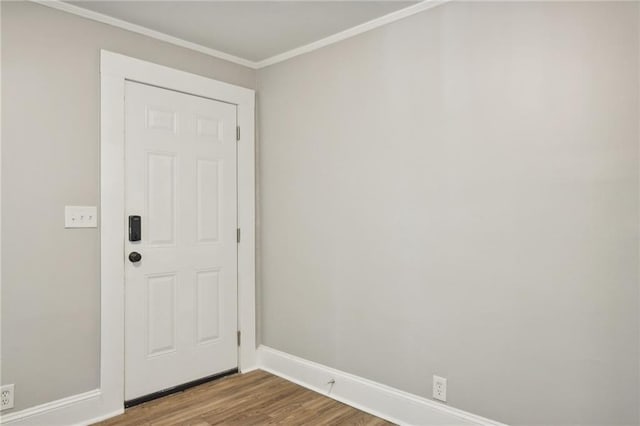 entryway featuring hardwood / wood-style flooring and ornamental molding