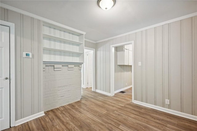 interior space with crown molding and hardwood / wood-style flooring