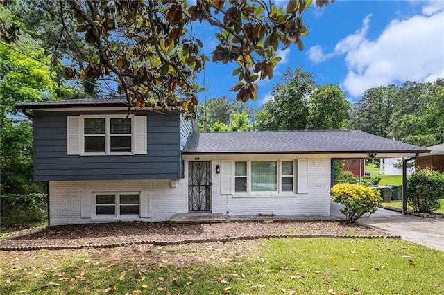 479 Charter Oak Dr SW, Atlanta, GA 30331 - tri-level home with a front yard, brick siding, and a carport