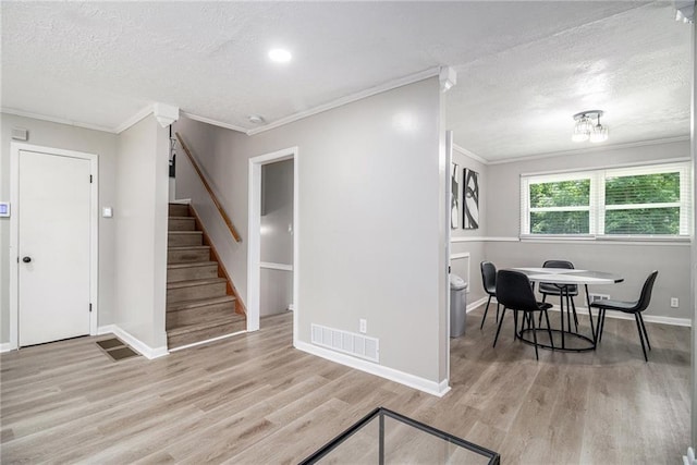 479 Charter Oak Dr SW, Atlanta, GA 30331 - dining area with ornamental molding, wood finished floors, stairway, a textured ceiling, and baseboards