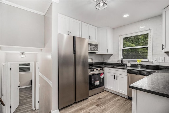 479 Charter Oak Dr SW, Atlanta, GA 30331 - kitchen featuring stainless steel appliances, a sink, dark countertops, white cabinets, and ornamental molding