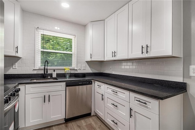 479 Charter Oak Dr SW, Atlanta, GA 30331 - kitchen with appliances with stainless steel finishes, a sink, white cabinets, light wood-style flooring, and backsplash
