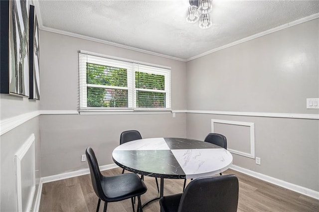 479 Charter Oak Dr SW, Atlanta, GA 30331 - dining room featuring wood finished floors, a textured ceiling, crown molding, and baseboards